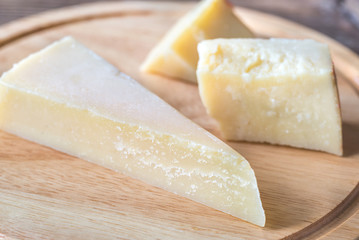 Grana Padano cheese on the wooden board