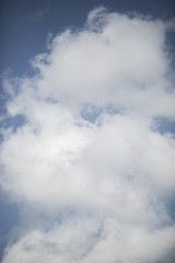 Deep blue sky overlay with white clouds
