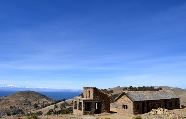 Stone cottage with thatched roof and stable on Isla del Sol in Lake Titicaca, Bolivia.