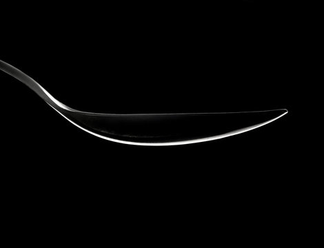 Spoon Outline Highlight Om A Black Abstract Background