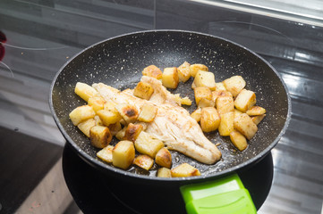 sea bass cooks with potatoes