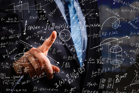 Side portrait of handsome young businessman writing mathematical formulas on bright city background