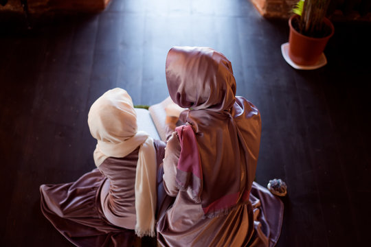 Muslim woman teaches children to read the Quran