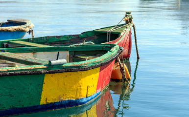 Fototapeta na wymiar Traditional colorful boats luzzu at the port of Marsaxlokk, Malta. Copy space, closeup view