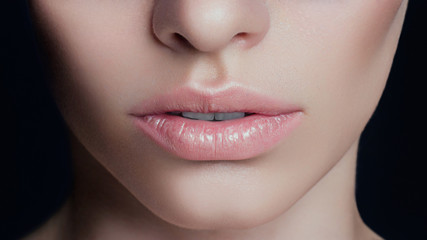 Sexual full lips. Natural gloss of lips and woman's skin. The mouth is closed. Increase in lips,...