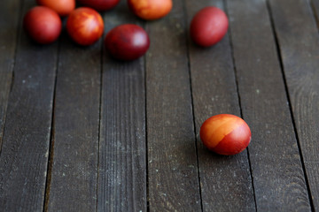 red Easter eggs on dark wooden background