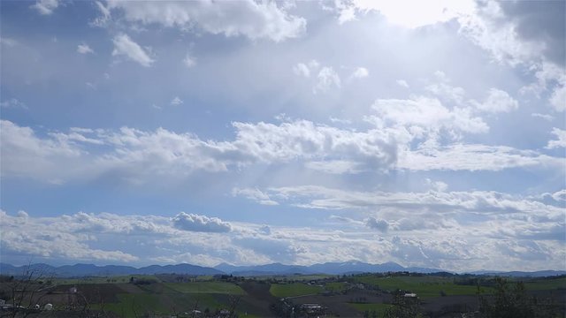 High angle time lapse shot of shadows of clouds passing over rural farmland / Corinaldo (Marches, Italy)