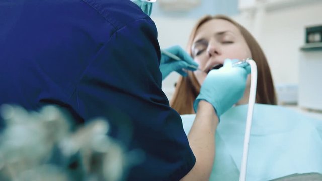 Dentist cheking teeth of girl