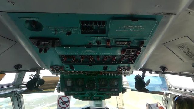 In the cockpit of the plane in place of the pilots.