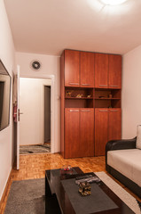Big wooden wardrobe commode in apartment interior