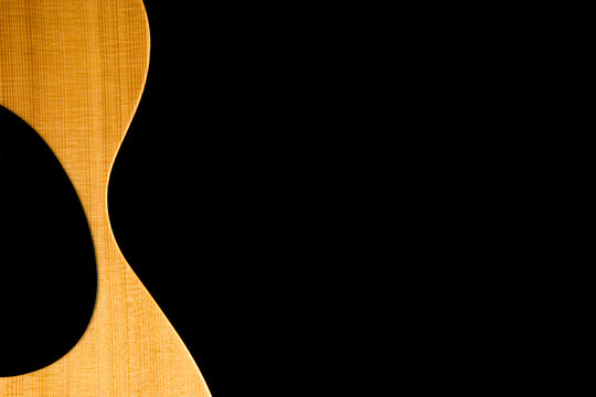 Acoustic Guitar Partial Body on Black Background