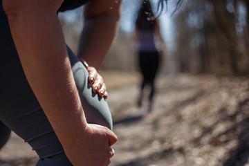 Woman touching leg, knee trauma at outdoor jogging