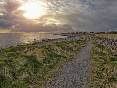 Footpath by the ocean at sunset at dusk. 