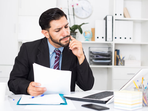 Spanish male worker is having complicated issue with project