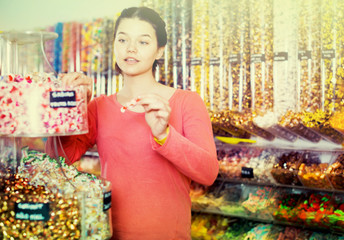  girl buying candies at shop