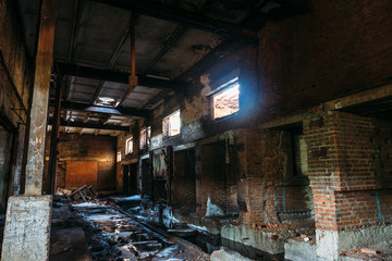 Ruins of abandoned industrial warehouse, dark creepy corridor of manufacturing factory workshop with columns, destroy and demolition concept