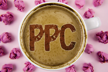 Writing note showing  Ppc. Business photo showcasing Pay Per Click Advertising Strategies Direct Traffic to Websites written on Coffee in white Cup within Paper Balls on plain background.