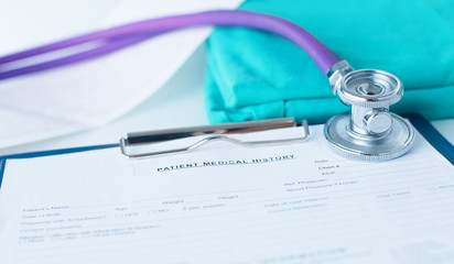 Stethoscope on a table with medical uniform