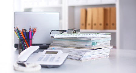 Workplace with notebook laptop Comfortable work table in office windows and city view