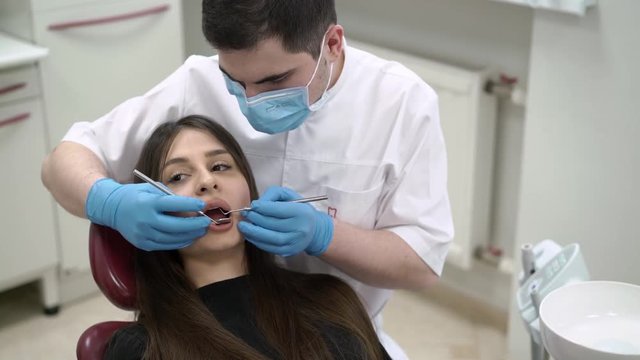 Dentist doctor checking patient teeth in dental clinic