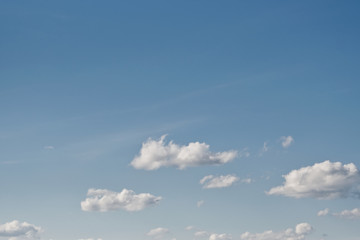 Clear blue sky with plain white cloud with space for text background.