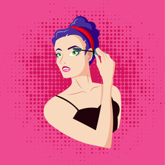 The girl paints the eyelashes