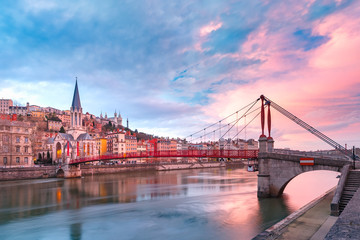 Saint Georges church and footbridge across Saone river, Old town with Fourviere cathedral at gorgeous sunset in Lyon, France