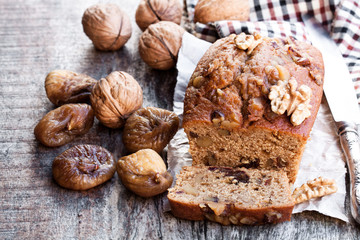 Homemade  fig and walnut loaf cake on old wooden table