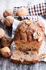 Homemade  fig and walnut loaf cake on old wooden table