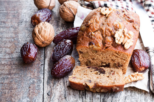 Homemade  date and walnut loaf cake on old wooden table