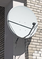 Satellite antenna on wall of brick building