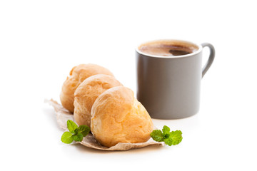 Homemade  profiteroles with cup of coffee isolated on white