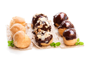 Homemade  assorted profiteroles isolated on white