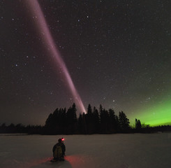 The Northern Lights and atmospheric phenomenon 'STEVE' which appears as a purple and green light ribbon in the sky. 'STEVE' is caused by a 25 km wide ribbon of hot gases at an altitude of 450 km