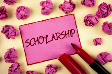Word writing text Scholarship. Business concept for Grant or Payment made to support education Academic Study written on Pink Sticky Note Paper on plain background Paper Balls and Marker.