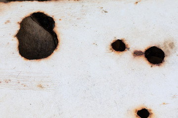 White metal with rust holes