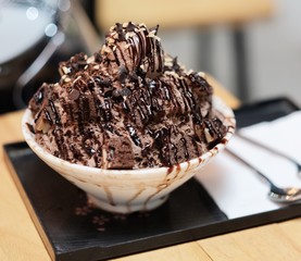 Chocolate ice snowflakes with chocolate ice cream and brownies topping. This is famous dessert in hot summer. 