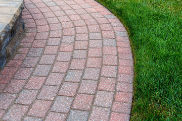 Fototapeta premium Beautiful brick sidewalk with nice grass edge.