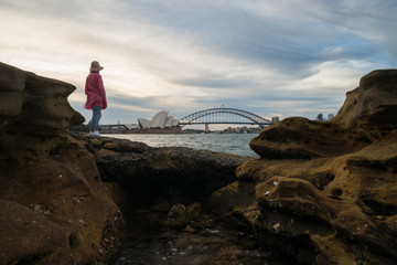 A woman views the Harbour Bridge in Sydney Australia