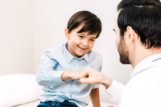 Doctor giving fist bump with patient boy in hospital.healthcare and medicine