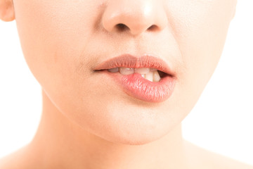 Obraz premium Close-up of female lips mouth biting lip isolated on white background