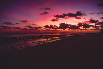 Fototapeta na wymiar Bright colorful sunset or sunrise at ocean with clouds in Bali