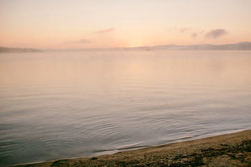 gentle soft light pink dawn on the big lake, sunrise