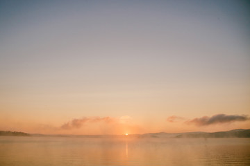 gentle soft light pink dawn on the big lake, Sunrise, calm, fog