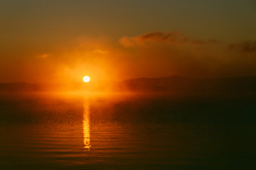 dark light pink dawn on the big lake, sunrise, big orange sun