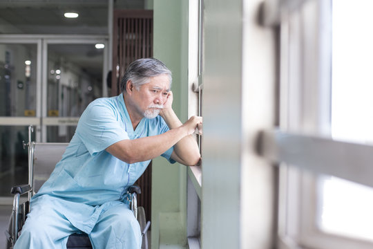 Asian Old Man Sit On Wheelchair Looking Out To Other Place. People With Health Care And Medical Concept.