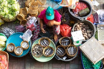 Fish street vendor selling fishes at market in Ubud town, Bali, Indonesia.