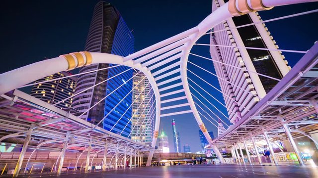 Time-lapse of People walking at Chong Nonsi skywalk at night, Bangkok, Thailand
