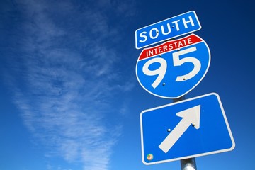 I-95 South Sign in Afternoon Sun Against Blue Sky with Scattered Clouds