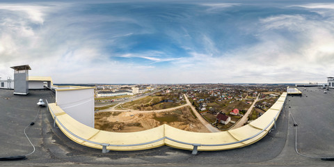 Fototapeta na wymiar Aerial panorama 360 angle view from roof of multi-storey building with view oт village in summer day. Full spherical 360 degrees seamless panorama in equirectangular projection, VR AR content